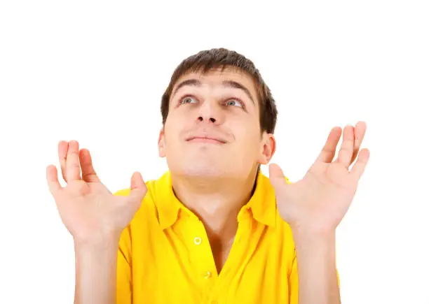 Happy Young Man crossing his Fingers Isolated on the White Background