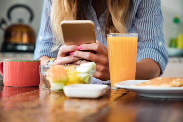 istock Young adult woman using smartphone in a modern home. 1400990630