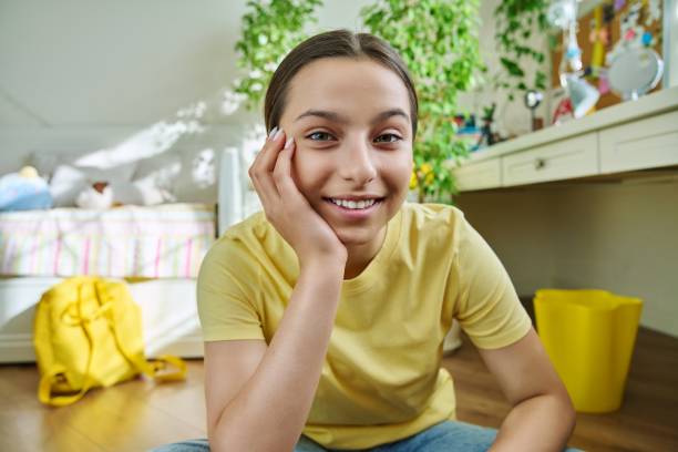 istock Teenage female student having video call, looking at webcam 1400990926