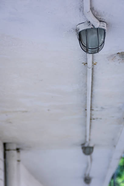 istock Line of iron industrial lights on the white ceiling 1400991647