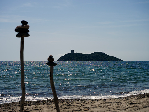 Peebles piled up on sticks, placed on anywhere lonely and  pristine beach