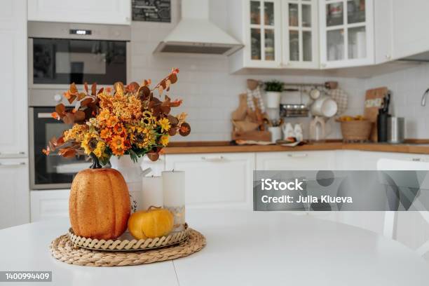 Stilllife Yellow Orange Flowers In A Vase Pumpkins And Candles On A Golden Tray On A White Table In A Home Kitchen Interior A Cozy Autumn Concept Stock Photo - Download Image Now
