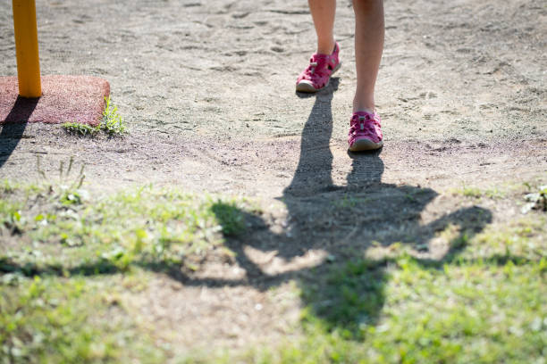 istock Feet and shadows of a child practicing an iron bar 1400994667