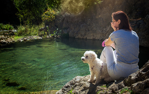 Woman with maltipoo puppy outdoors