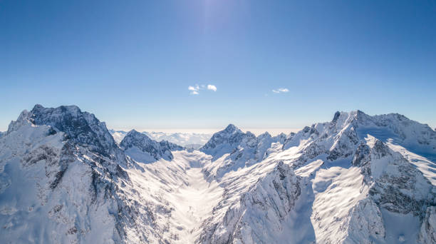 istock Amazing mountain peak covered with snow against the blue sky 1400998337