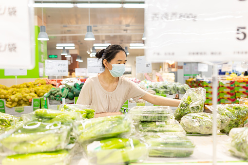 Asian Housewife Choose Fresh Vegetables in Supermarkets