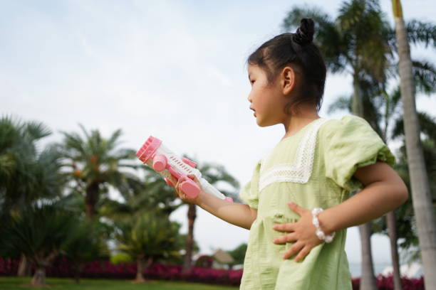 Little girl playing bubble machine