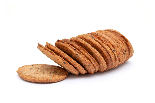 Broken stem ginger biscuit with crumbs isolated on white. Top view.