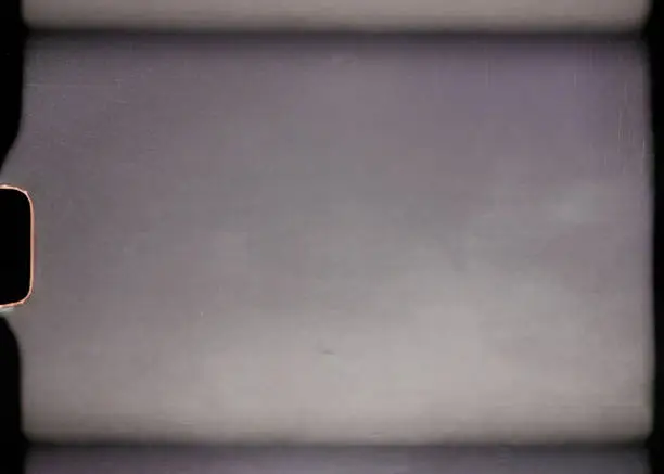 Photo of scan of blank or empty 8mm film frame with dust and scratches