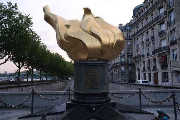 People visiting the Place Diana Paris, France - April 22, 2022. People visiting the Place Diana with the Flame of Liberty Monument near Alma Bridge along the Seine River princess of wales stock pictures, royalty-free photos & images