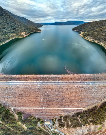 Dartmouth Dam is a large rock-fill embankment dam with an uncontrolled chute spillway across the Mitta Mitta, Gibbo, and Dart rivers. The dam is located in the north-east of the Australian state of Victoria. The dam's purpose includes irrigation, the generation of hydro-electric power, water supply and conservation. The impounded reservoir is called Dartmouth Reservoir, sometimes called Lake Dartmouth. The Dartmouth Power Station, a hydro-electric power station that generates power to the national grid, is located near the dam wall. It is the largest capacity storage in the River Murray system. It has the highest embankment of any dam in Australia.