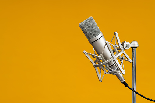 Condenser microphone on yellow background.