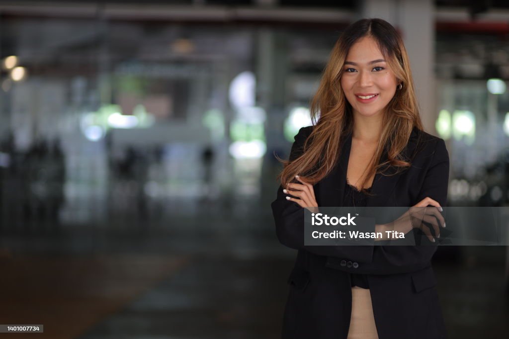 Portrait of a happy charming business woman looking at the camera in the office. Real Estate Agent Stock Photo
