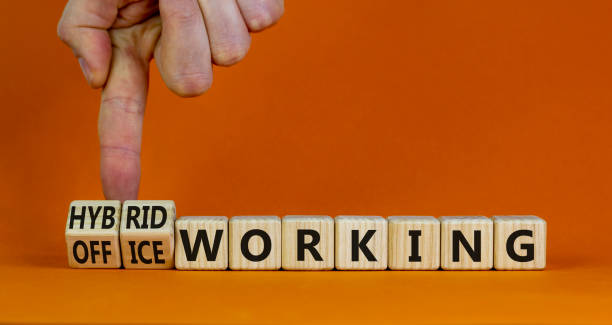 istock Hybrid or office working symbol. Businessman turns cubes and changes words 'office working' to 'hybrid working'. Beautiful orange background. Business, hybrid or office working concept, copy space. 1401009544