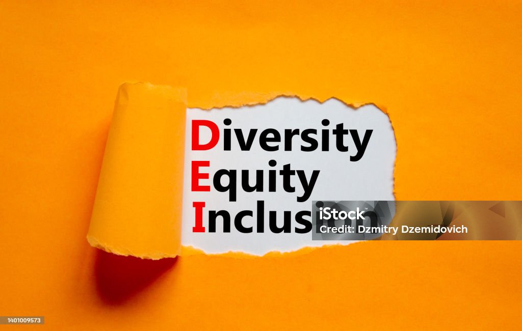 Diversity, equity, inclusion DEI symbol. Words DEI, diversity, equity, inclusion appearing behind torn orange paper. Orange background. Business, diversity, equity, inclusion concept, copy space. Social Inclusion Stock Photo