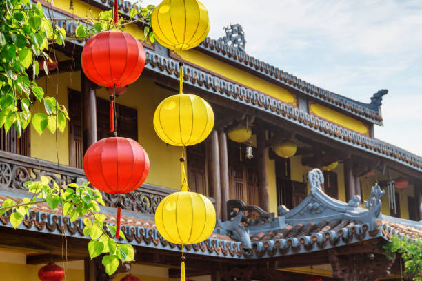 istock Yellow and red silk lanterns on green branches of tree 1401010804
