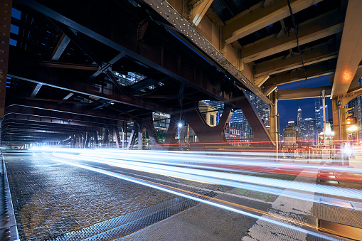 Light trails of cars on bridge. Night scene of city street in Chicago.