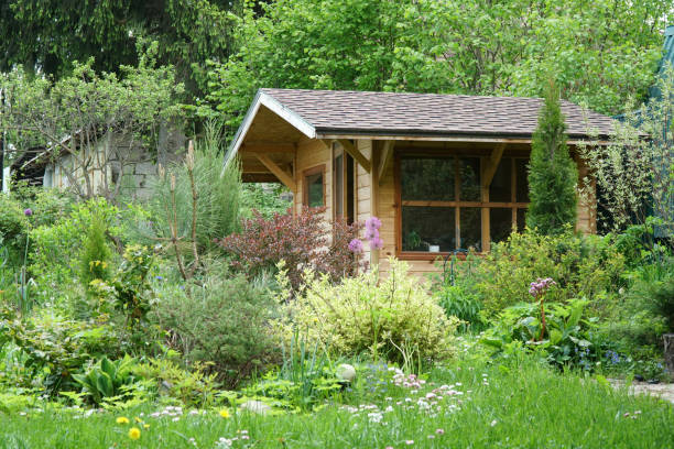 istock Small house in a flowered garden in summer 1401011796