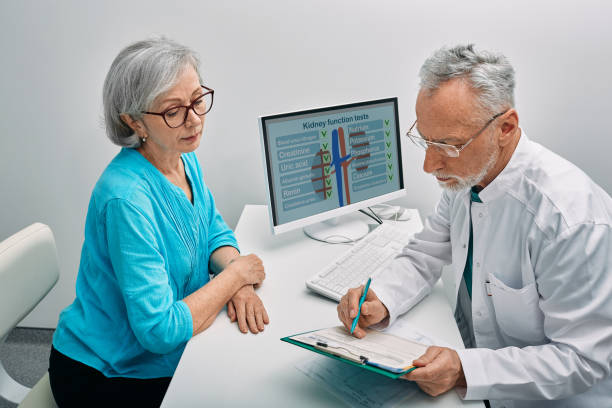 Senior woman during a consultation with a urologist about kidney disease and treatment at medical clinic. Kidneys health stock photo