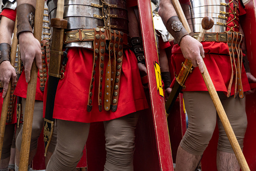 soldiers in a historical reenactment in easter. People performing a Roman legion. Hands and legss shoot  with soldier uniforms and weapons