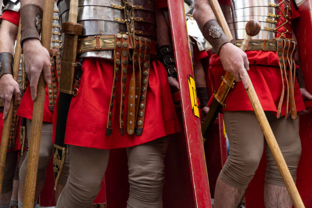roman soldiers in a historical reenactment in easter. People performing a Roman legion soldiers in a historical reenactment in easter. People performing a Roman legion. Hands and legss shoot  with soldier uniforms and weapons roman centurion stock pictures, royalty-free photos & images