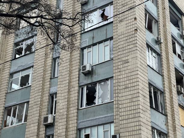 residential building damaged by rocket shelling - distress rocket imagens e fotografias de stock