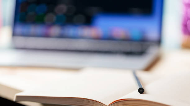istock Home office with open laptop on blurred background. Notepad, pencil and laptop on a wooden table. Education business lifestyle concept. Soft focus. Copy space 1401018367