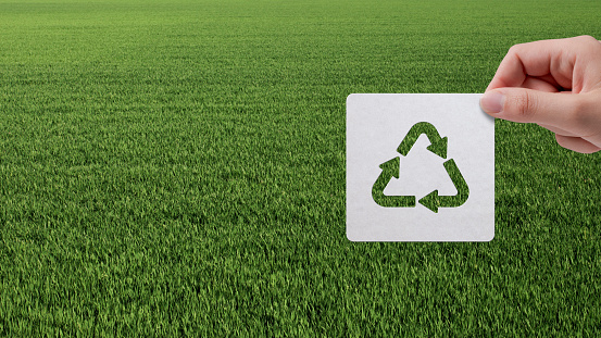 Green recycling symbol, recycle icon on blue background. 3D rendering