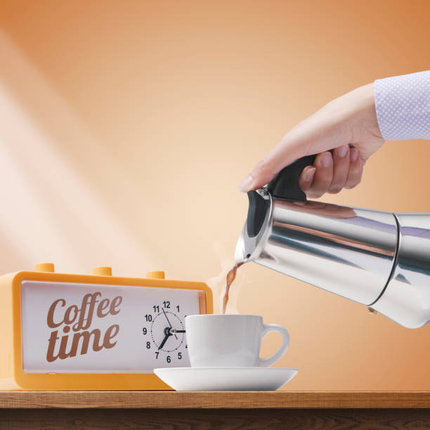 istock Woman pouring hot coffee in a cup 1401019638
