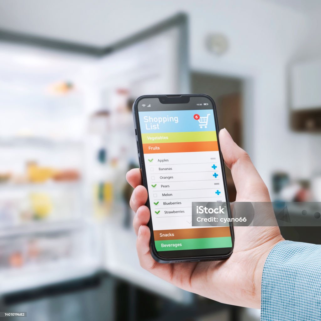 Woman Using A Grocery Shopping List App Stock Photo - Download Image