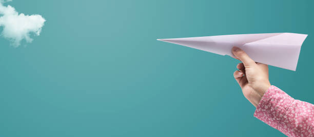 istock Woman holding a paper airplane 1401019836