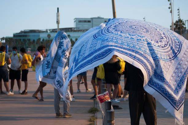 People selling pareo or beach towels at the beach. Wind stock photo