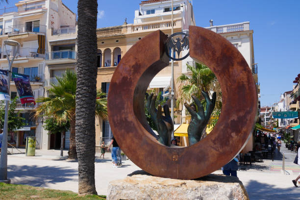 Bacardi statue sculpture monument by Lorenzo Quinn "Mirada al futuro" on paseo de la Ribera in Sitges stock photo