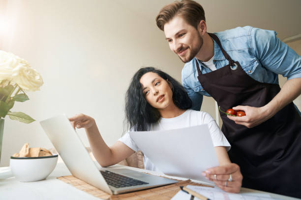 istock Female and male staring at laptop screen 1401020677