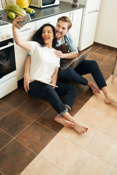 istock Funny young couple taking photos with smartphone 1401020704