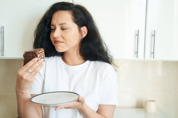 istock Young female experiencing aversion to sweet food 1401020740