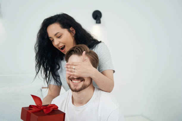 istock Loving female giving present to beloved man 1401020827