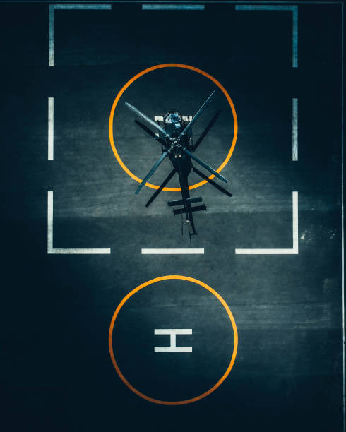 Top view from drone of helicopter standing at helipad in airport