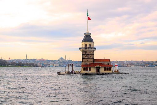 Istanbul, Turkey - May 8, 2016: Small boat view with Maiden's Tower in Istanbul, It's one of the symbols of Turkey and there is a part of the Bosphorus at the background with people. Some of people visits the restaurant in tower.