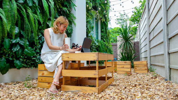 istock Woman using a laptop with dog on a park bench 1401021375