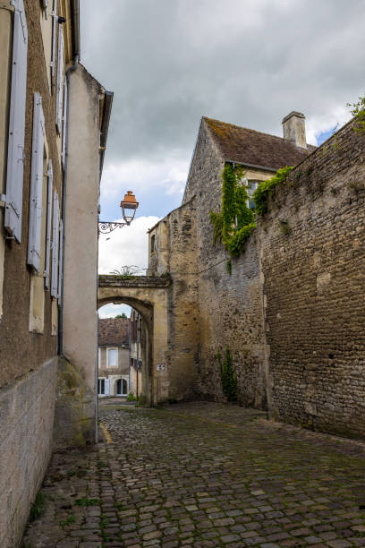 istock Old alley in Falaise on a cloudy day 1401021380