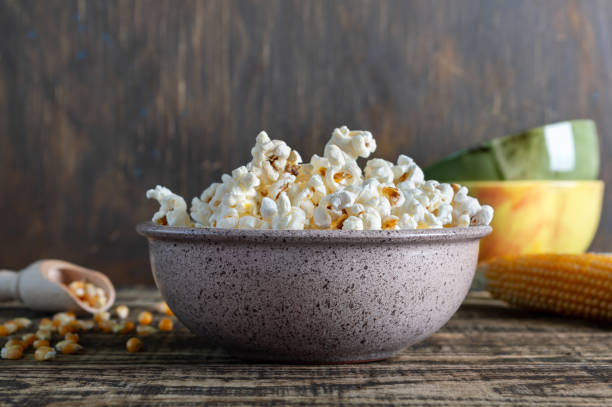 istock Freshly cooked popcorn in a bowl on a wooden table. Rustic style. 1401024450