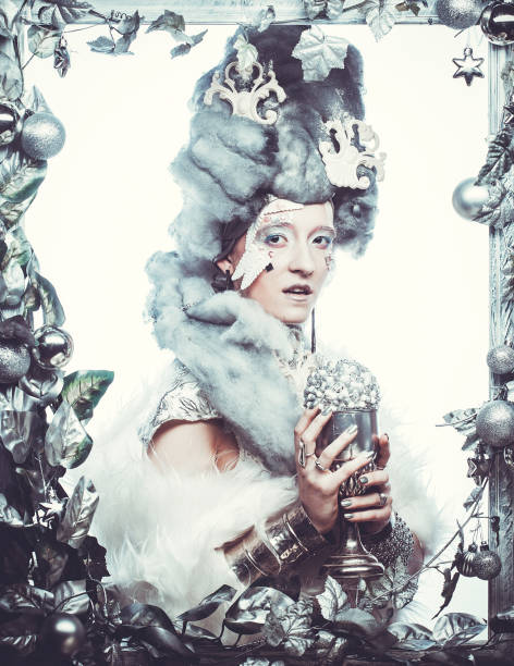 istock Young woman in creative image with silver artistic make-up holding christmas ball 1401024664