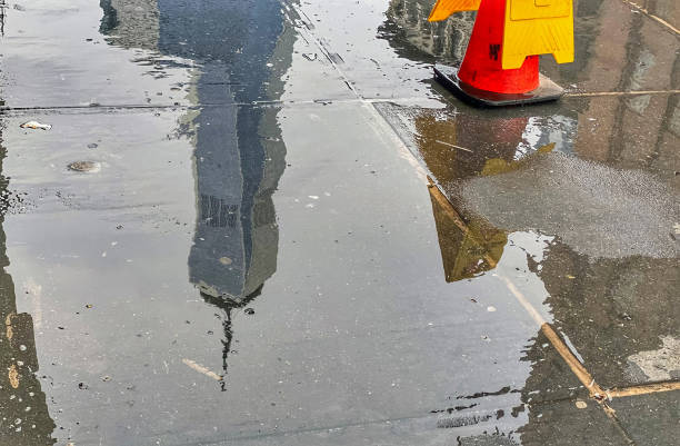istock A New York City skyscraper is reflected in a Tribeca wet sidewalk 1401026532