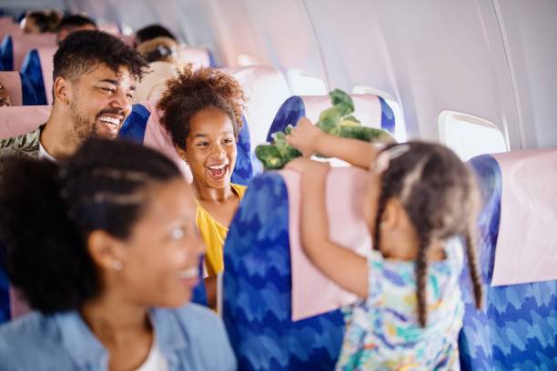 The sisters play with plush toys while traveling by plane
