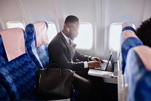Business person working on presentation during flight