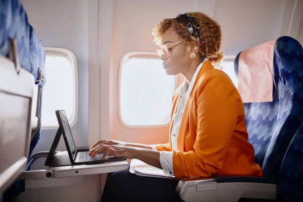 istock Businesswoman working on digital tablet during flight 1401028590