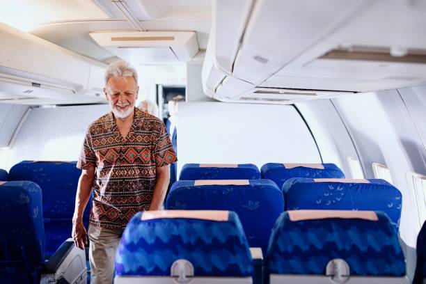 istock Passengers boarding plane and searching for their sets 1401029116