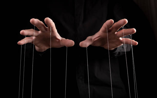 Man hands with strings on fingers. Manipulation, negative influence or addiction concept. Becoming dependent on alcohol, drugs, gambling. Man hands with strings on fingers. Manipulation, negative influence or addiction concept. Becoming dependent on alcohol, drugs, gambling. High quality photo puppet master stock pictures, royalty-free photos & images