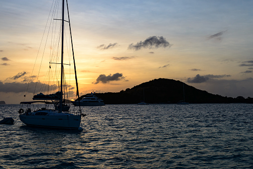 Sunset in the Tobago Cays - Saint Vincent and The Grenadines with sailing yacht in the background